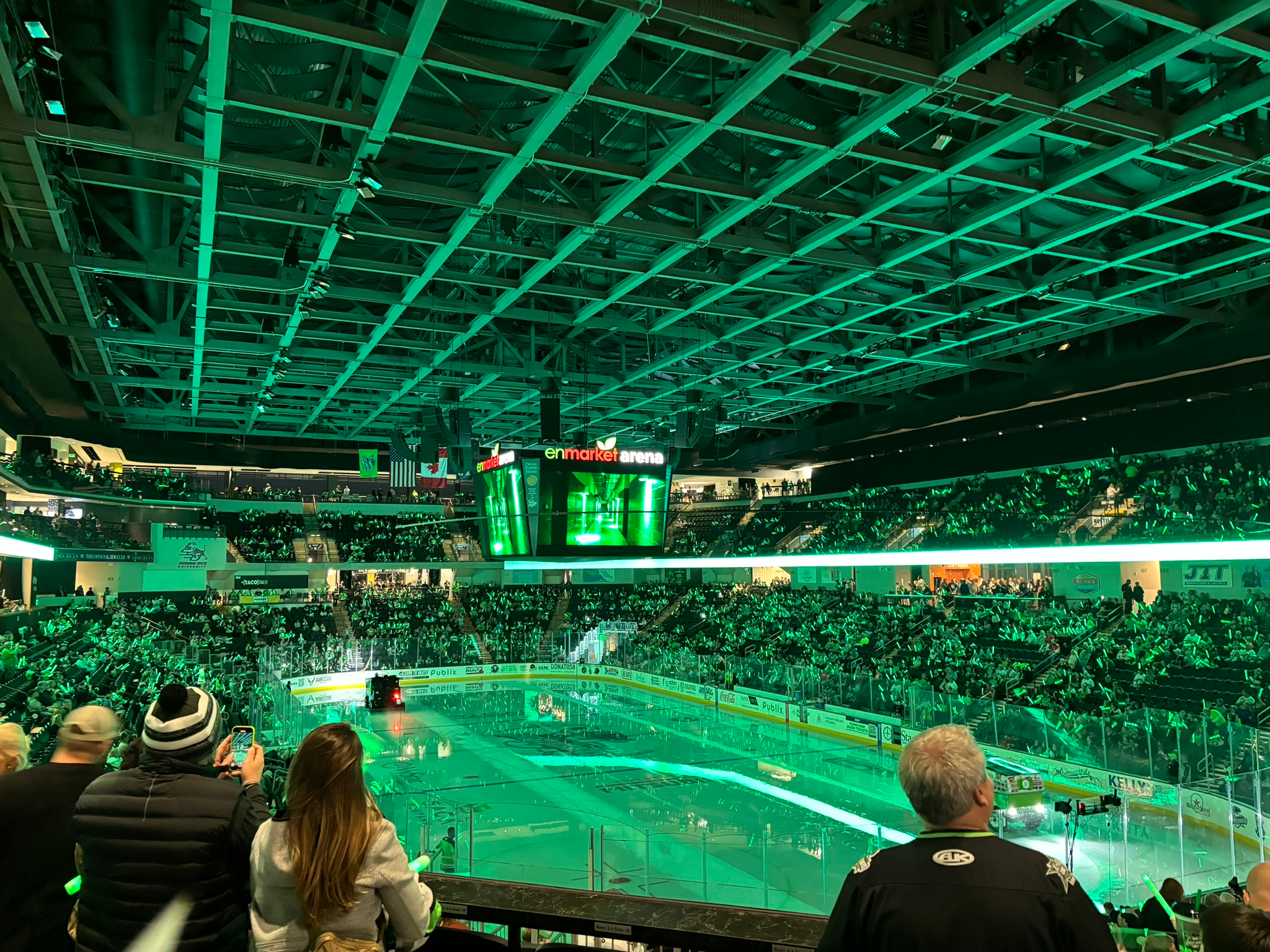 Packed hockey arena with dramatic lighting