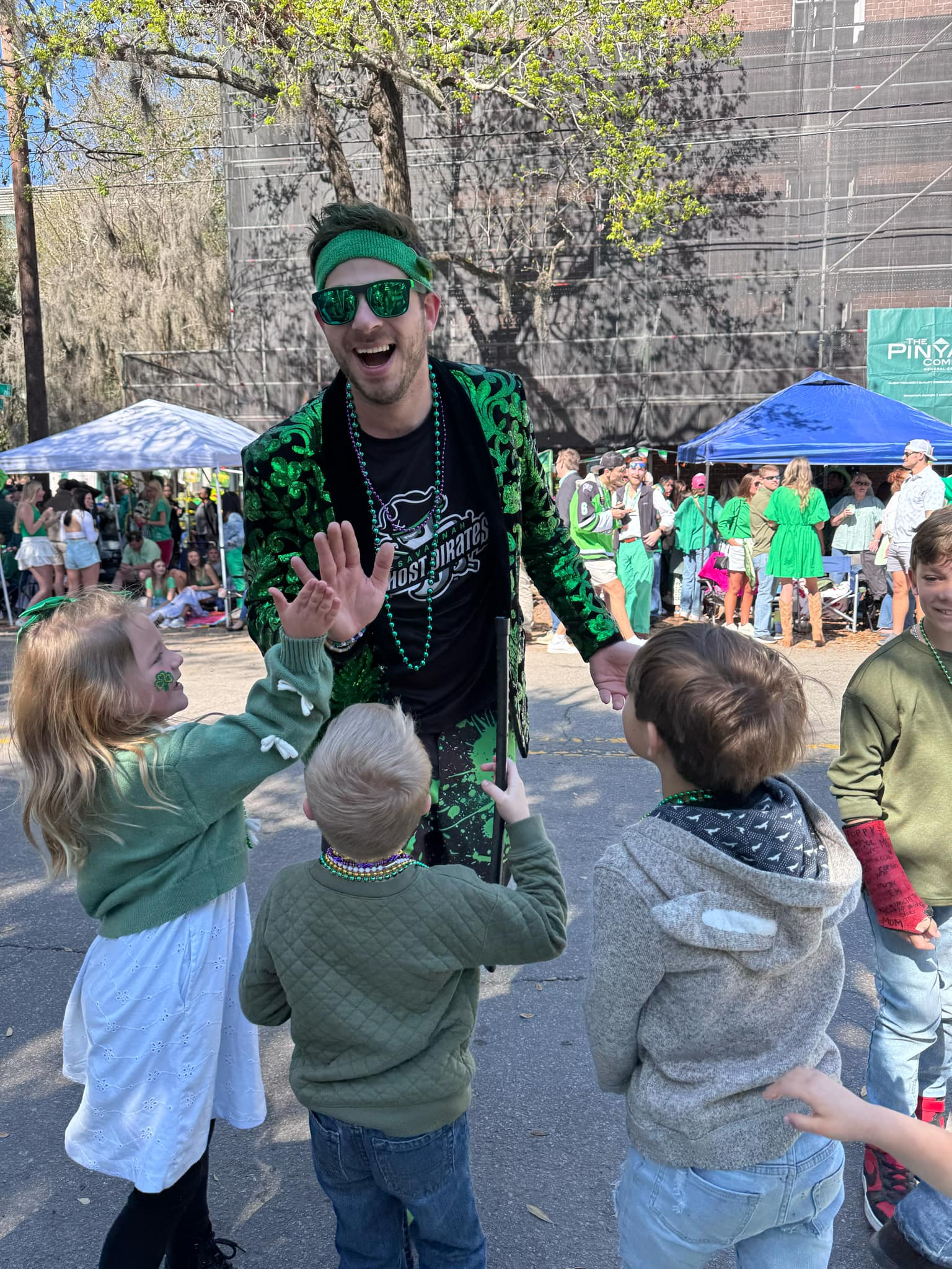 Benji high-fiving kids at a parade