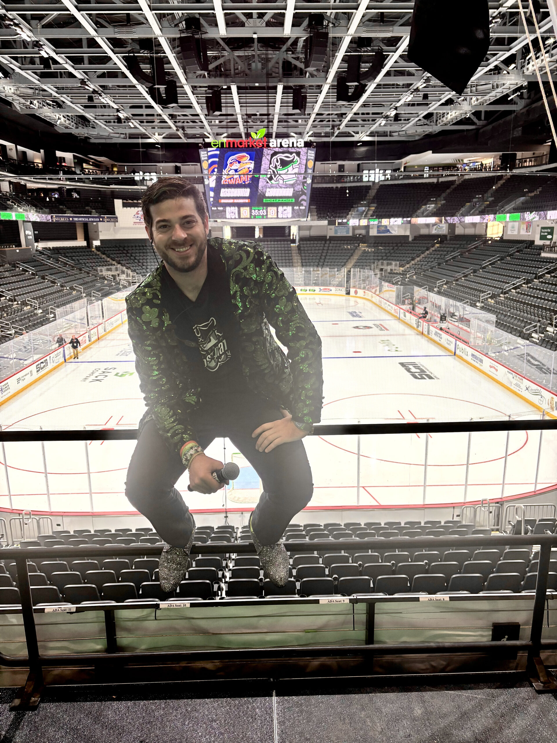 Packed hockey arena with dramatic green lighting