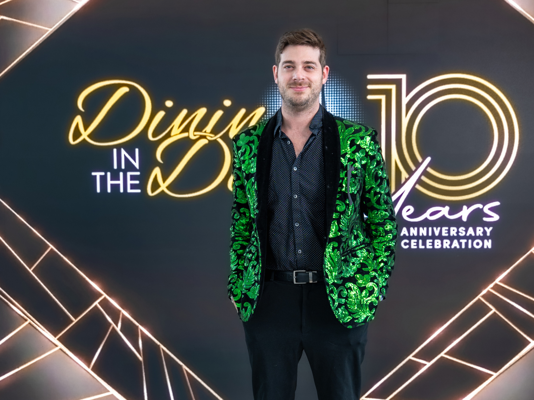 Benji seated in a gold-trim lounge setting